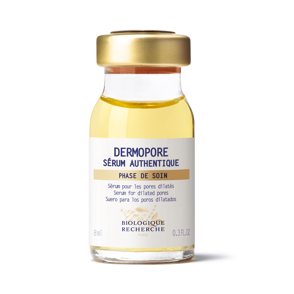 Glass bottle of Dermopore serum with gold cap on a white background